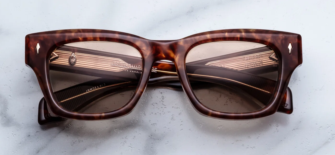  Front view of Jacques Marie Mage Dealan 53 sunglasses in Honeycomb, featuring a bold Havana tortoiseshell 10mm acetate frame, translucent yellow-gold honeycomb CR39 lenses, and light gold signature arrowhead front pins.