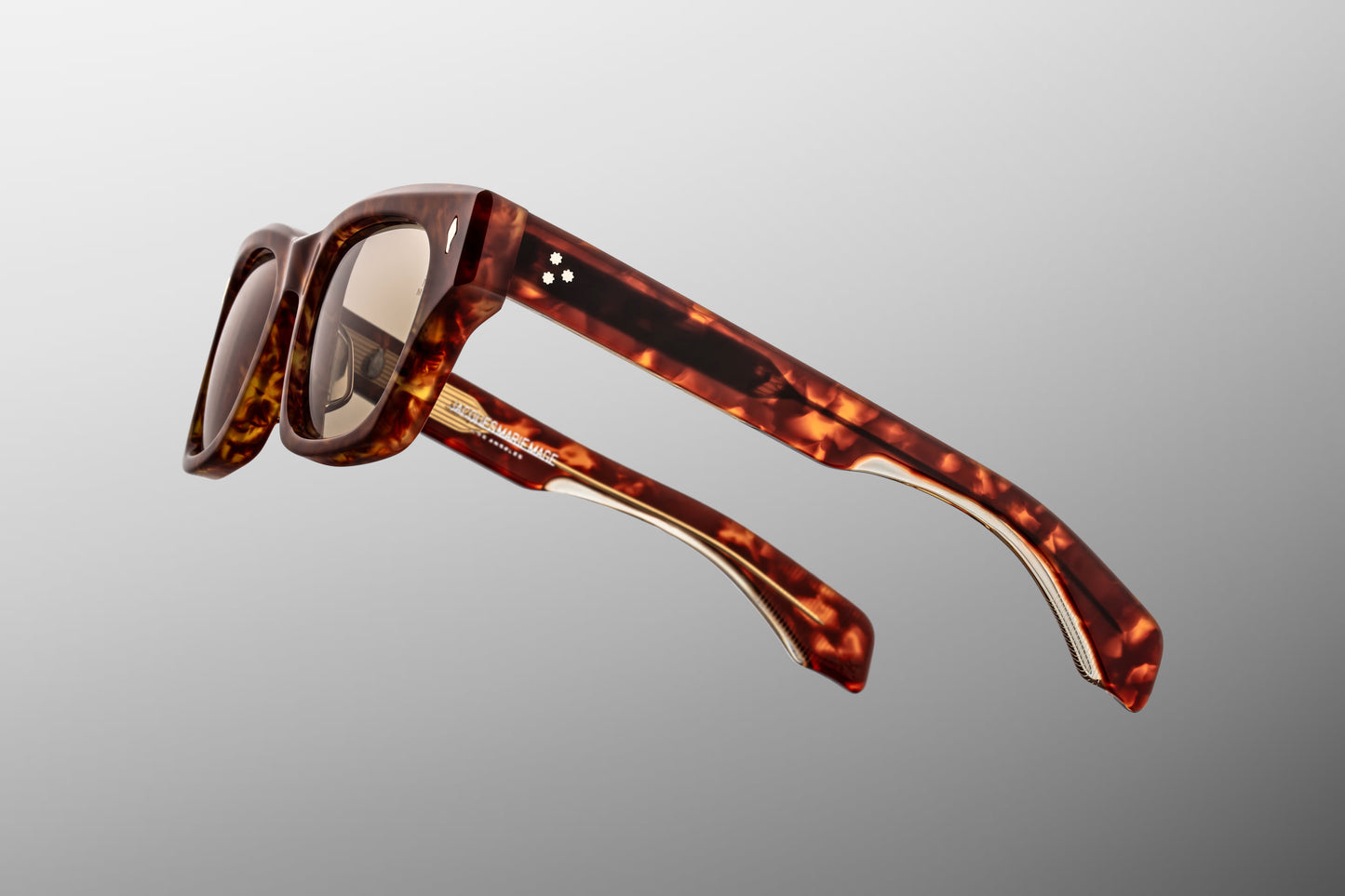 Side profile view of the Jacques Marie Mage Dealan 53 in Honeycomb, displaying the custom double-laminated acetate temples exposing the inner light gold custom wirecore with intricate hairline engraving