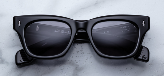 Jacques Marie Mage Dealan sunglasses in Raven front view – bold square black acetate frame with dark lenses and signature arrowhead rivets – available at Wink Optometrists