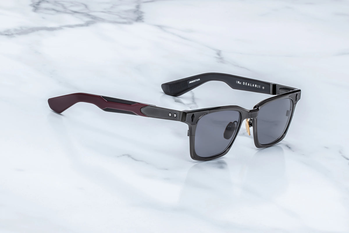 Side profile of JMM Dealan Ti glasses showing the sleek titanium temple arms and custom hinge details.
