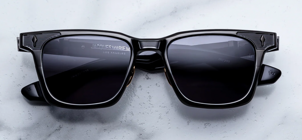 Front view of Jacques Marie Mage Dealan Titanium sunglasses with a thick titanium frame and dark lenses.