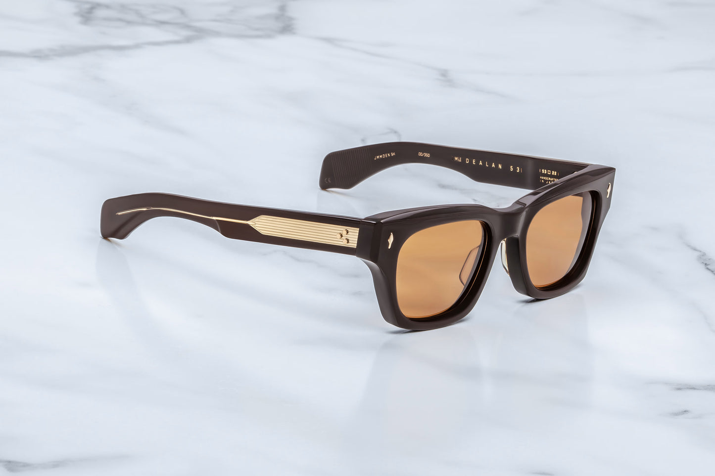  Three-quarter angle of Jacques Marie Mage Dealan 53 Walnut sunglasses, showing the thick sculptural acetate beveling and the transition from the rich brown front frame to the wide temples.