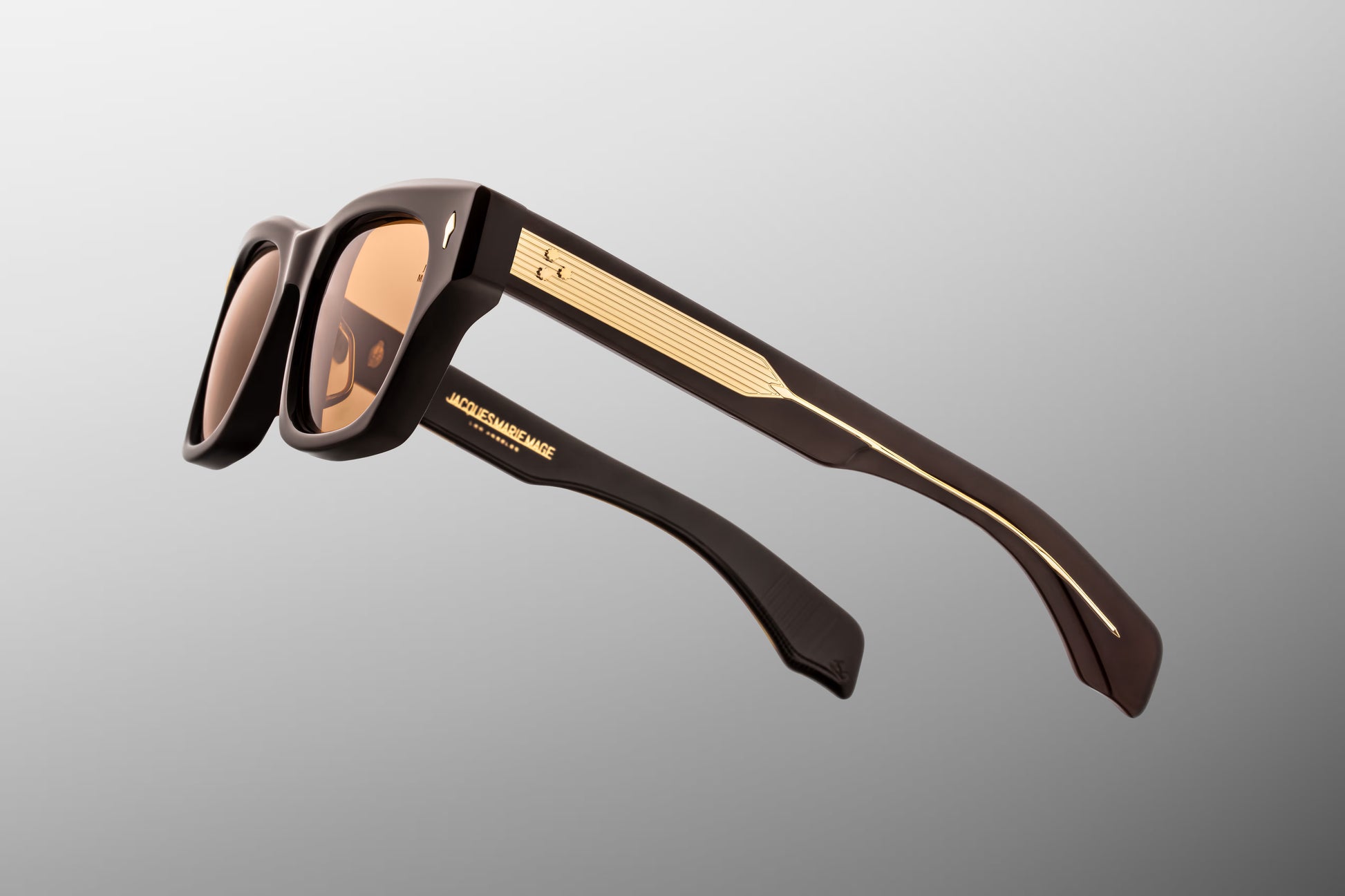 Side profile view of the Jacques Marie Mage Dealan 53 in Walnut, displaying the wide double-laminated acetate temples and the exposed dark gold custom wirecore with hairline engraving.