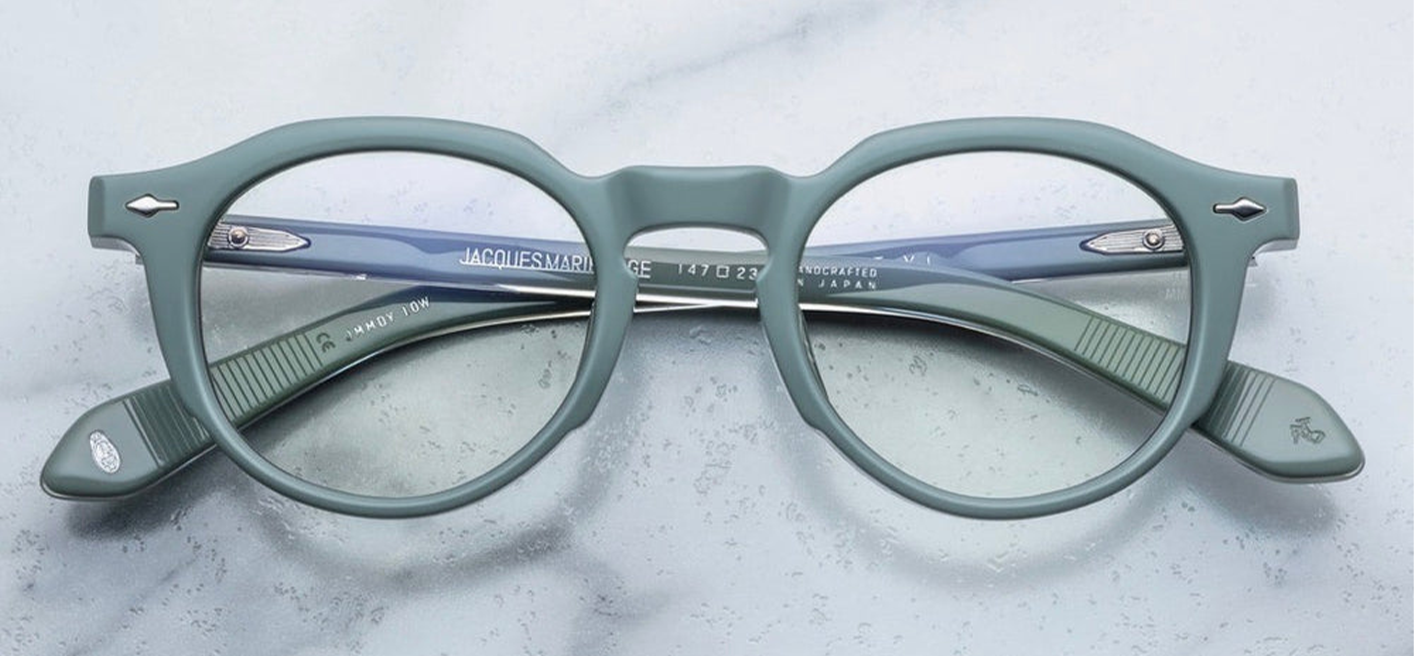 Front view of Jacques Marie Mage Demoncey Breathe—’40s‑inspired round eyeglasses in superlight green 10 mm cured cellulose acetate, featuring silver arrowhead front pins, wirecore temples, and robust monoblock titanium hinge