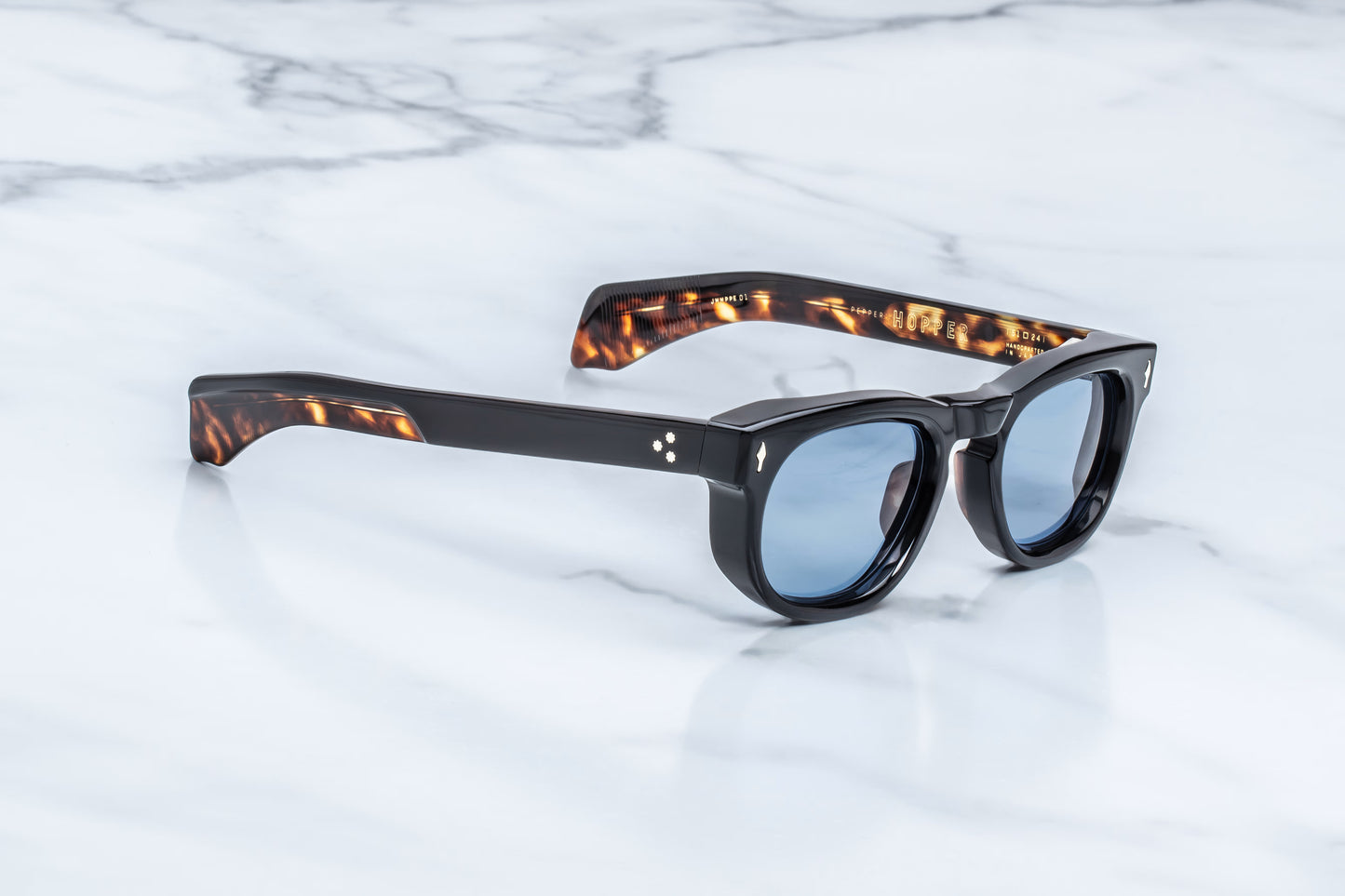 Three-quarter studio shot of the JMM Pepper 10Y Noir, highlighting the thick, sculpted block acetate frame, soft oval lens contours, and sleek transition into the temples