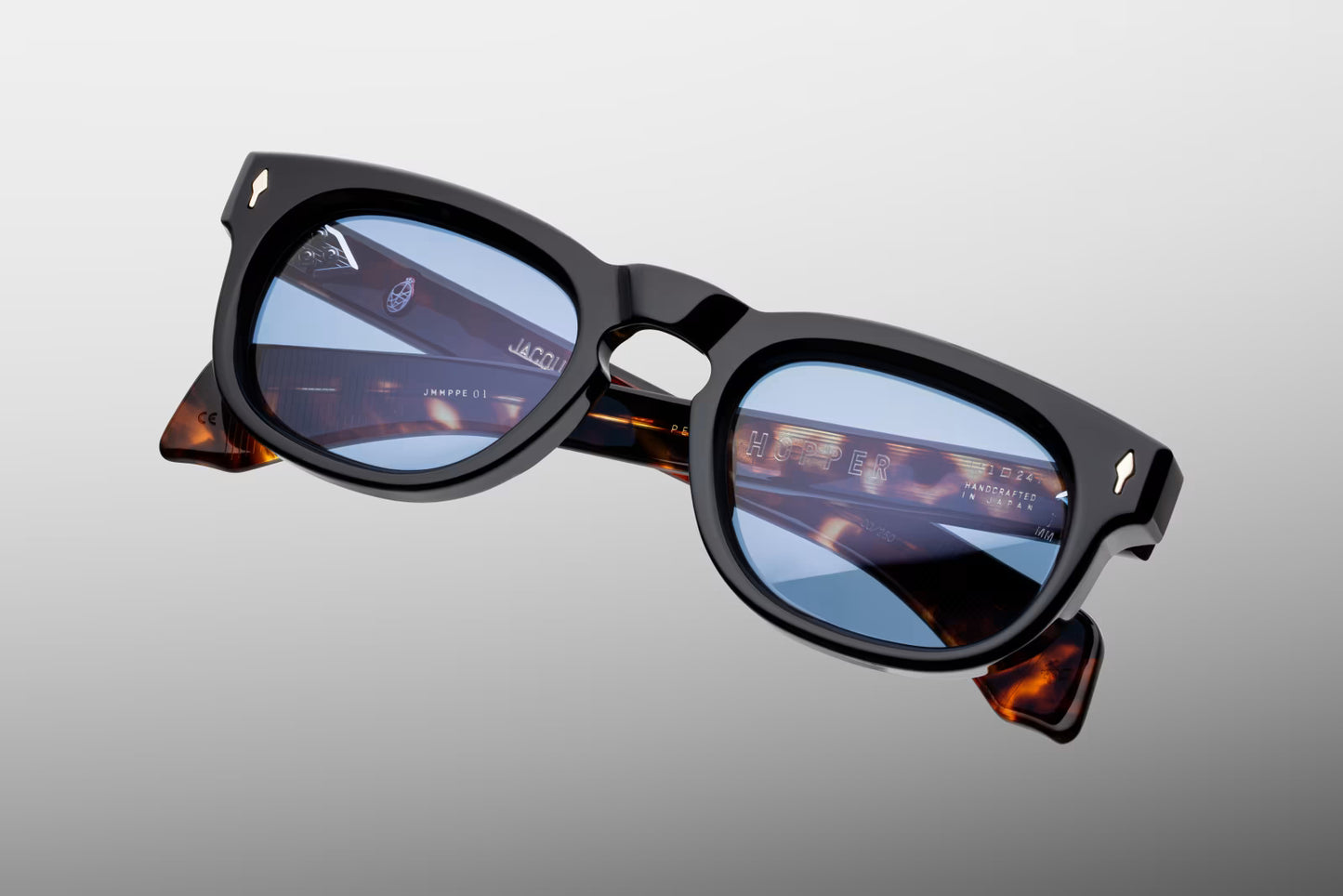 Top-down view of the JMM Pepper 10Y Noir sunglasses, revealing the frame’s distinct keyhole bridge curvature, the substantial thickness of the black acetate brow line, and heavy-duty 7-barrel hinges.