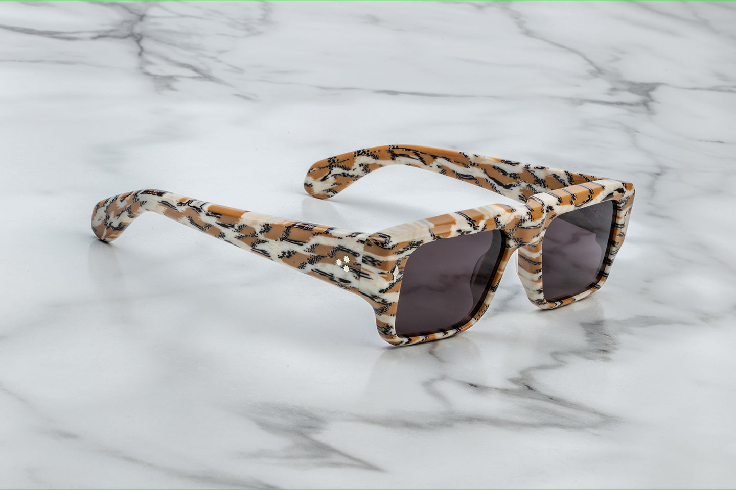 Side view of Jacques Marie Mage Devoto Cheetah sunglasses at WINK Optometrists Melbourne — showing patterned cheetah‑print acetate temple, exposed wire‑core detail and silver hardware.