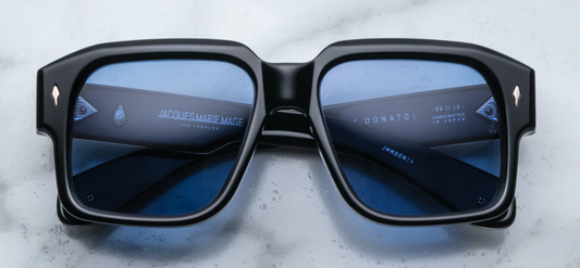 Front view of Jacques Marie Mage Donato Shadow sunglasses, featuring a bold, oversized square frame in a dark, sleek Shadow acetate finish with subtle tonal variations. The frame's sharp edges and angular design provide a contemporary, statement-making look. The dark lenses complement the frame's striking silhouette, offering both style and protection