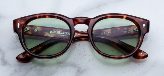 JMM Dr. Dream Baltic — softly sloping brow in translucent pale blue (Baltic) acetate, with keyhole bridge and sterling silver arrowhead front pins.