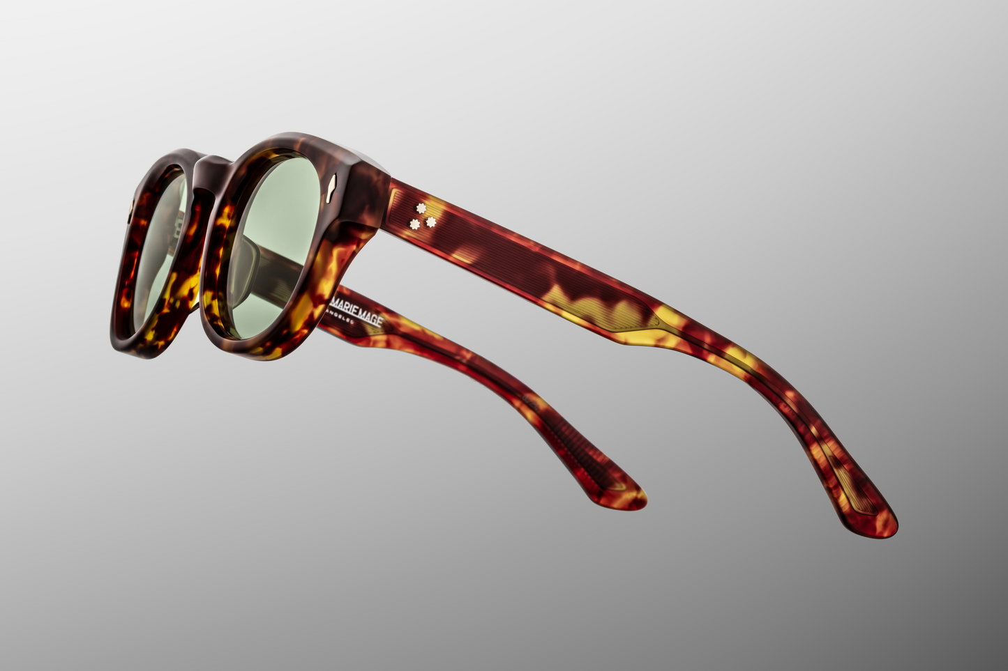 Close-up of the Dr. Dream Baltic hinge — silver-palladium custom 7-barrel hairline hinge and spur-shaped rivet on pale-blue acetate