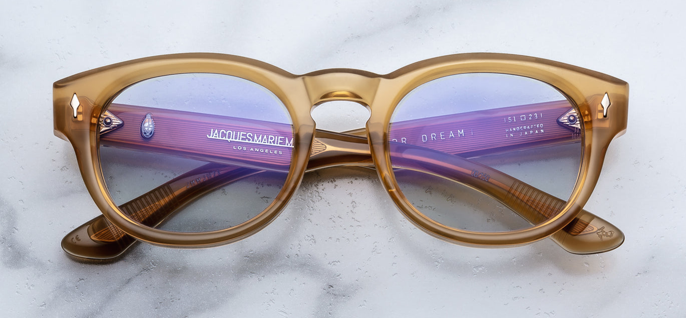 JMM Dr. Dream Marigold — classic John & Yoko mid-century frame in semi‑translucent orange‑marigold acetate with light‑gold arrowhead front pins.