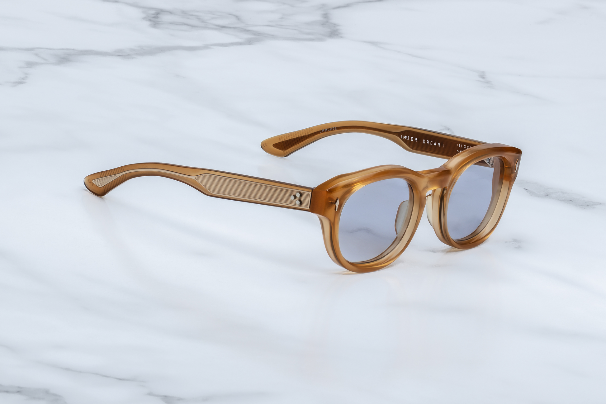 Side profile of Dr. Dream Marigold — double-laminated marigold acetate temples revealing exposed wire-core and a custom light‑gold 7‑barrel hinge
