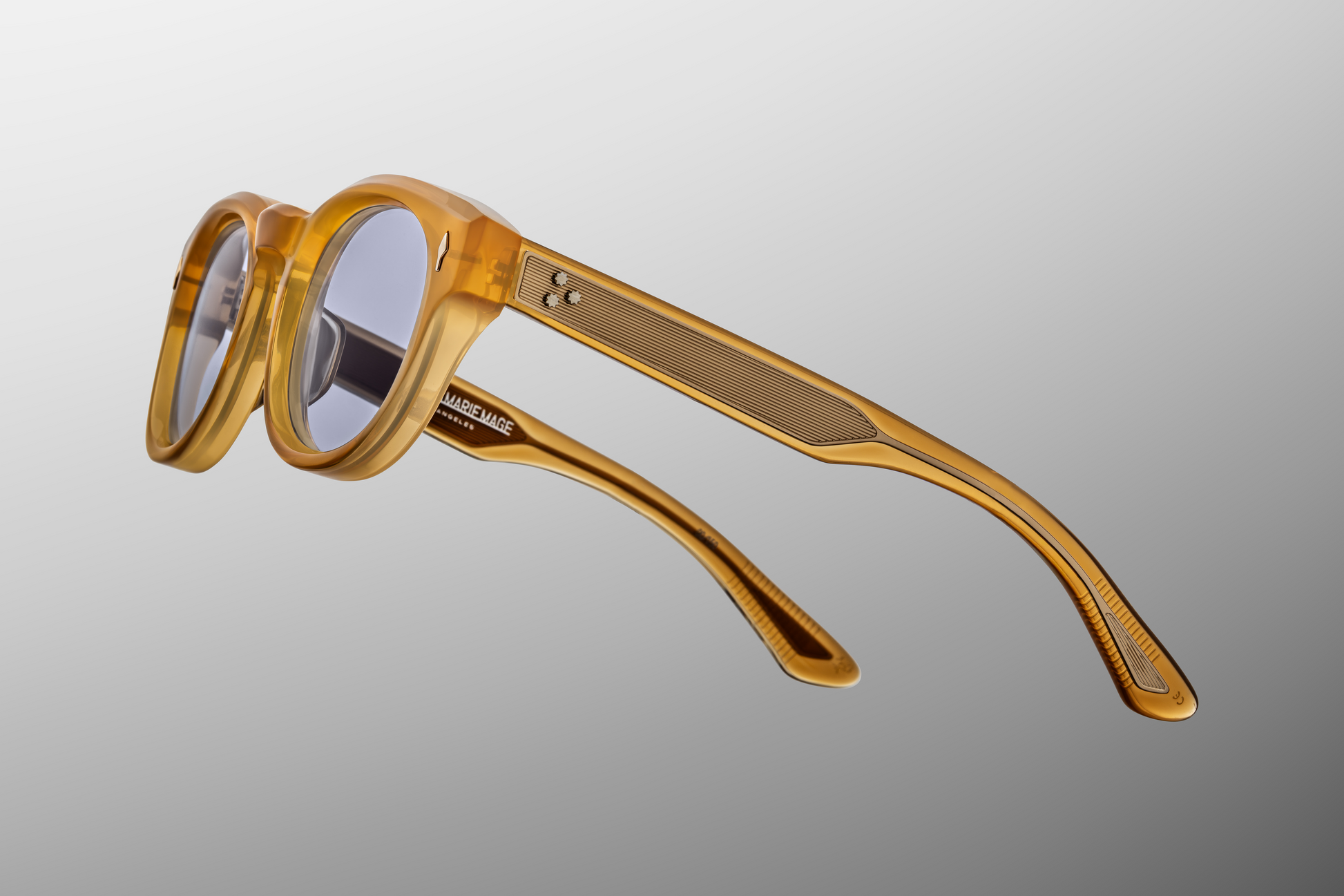 Close-up of Dr. Dream Marigold hinge — light‑gold 7‑barrel tension-secured hinge with spur rivets embedded in marigold acetate