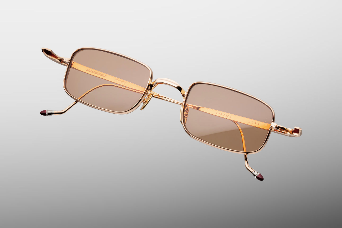 Top-down view of the JMM Dusk Sweetheart, revealing the compact, curved geometry of the micro eye-rims, matching rose gold nose pads, and concealed custom hidden hinges