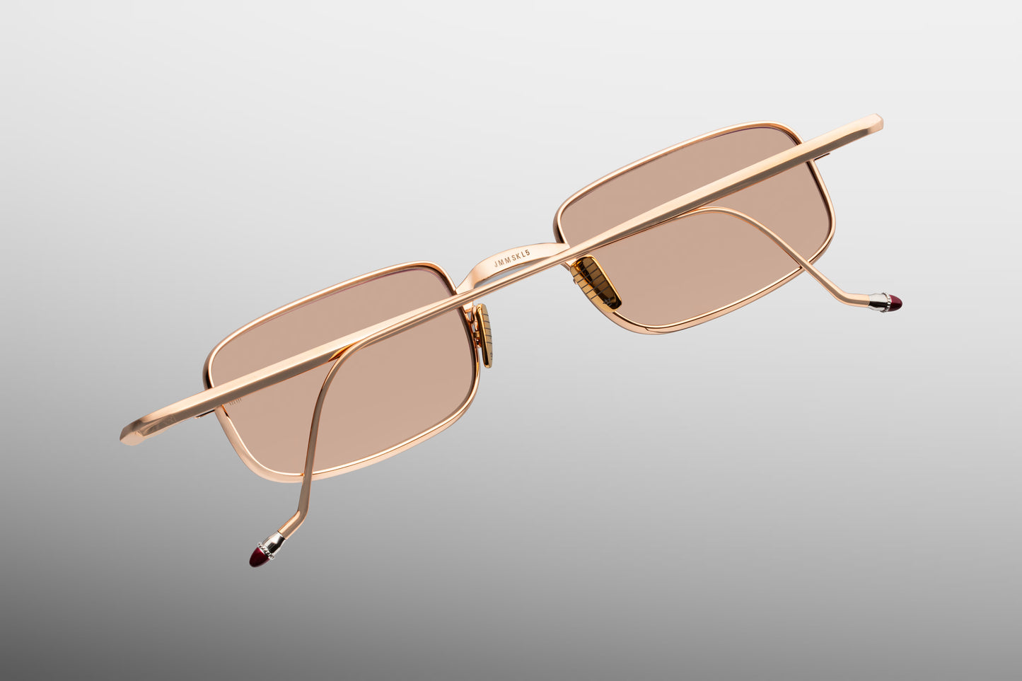  Rear perspective of the JMM Dusk Sweetheart temples, displaying the slim metal arms as they taper into the curved, hand-painted burgundy epoxy temple tips designed for an ergonomic fit.