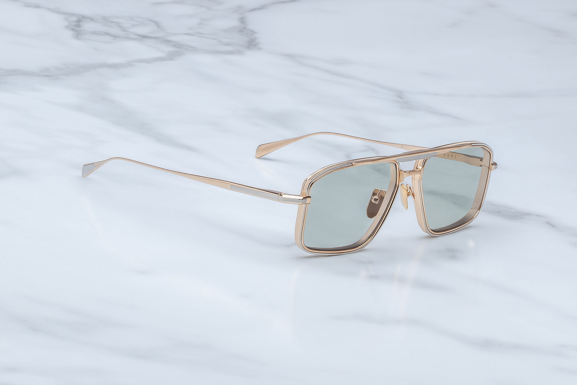 Side view of Jacques Marie Mage Earl Altan sunglasses: silver hairline-engraved titanium temples with wing tips, hidden tension-secured hinge, and custom logo nose pads. Limited edition of 500 pieces, handcrafted in Japan