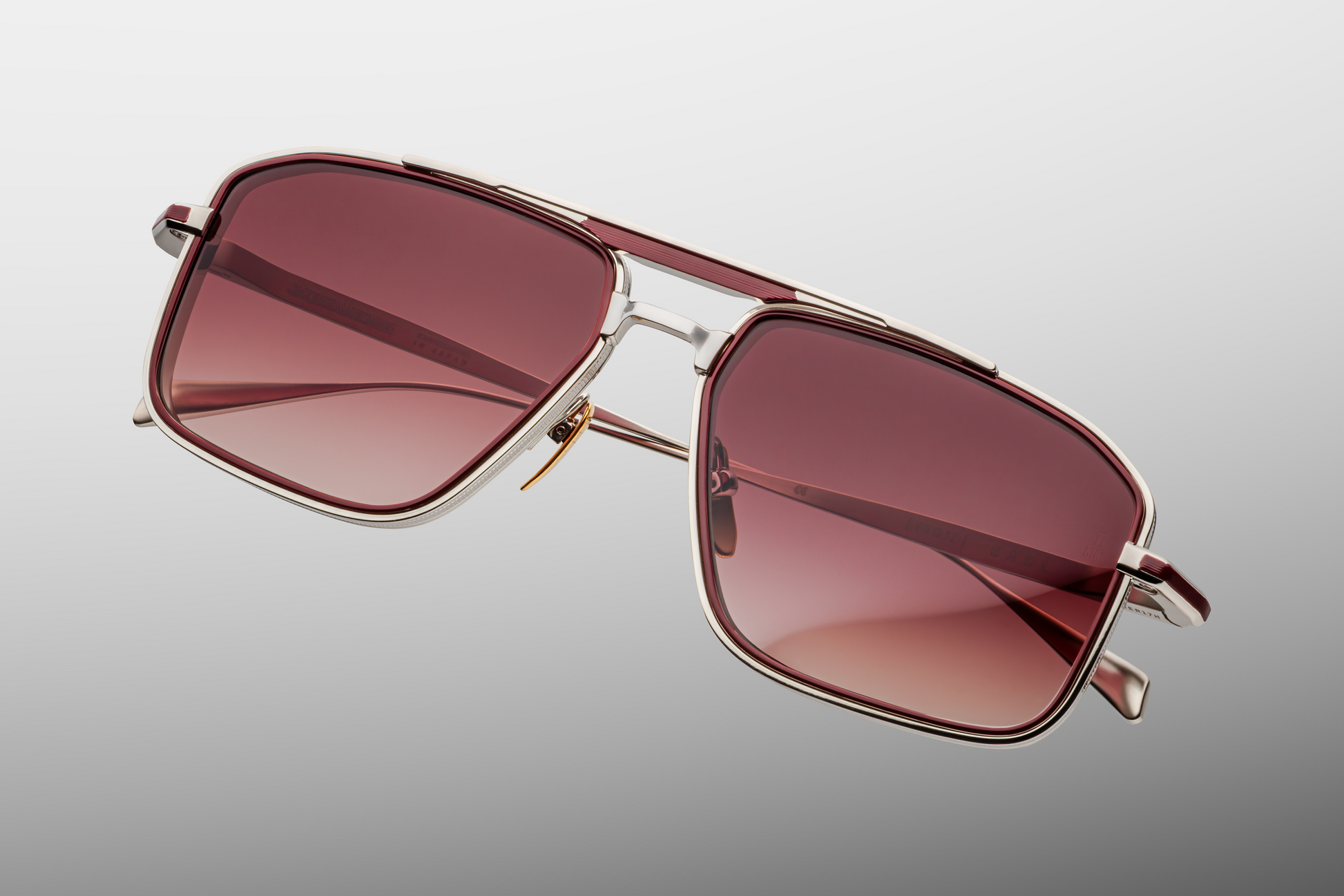 Top-down view of Jacques Marie Mage Earl Bordeaux highlighting medium fit (57‑17‑143 mm), wide navigator silhouette, and seamless integration of bordeaux eyerim inserts within the titanium frame