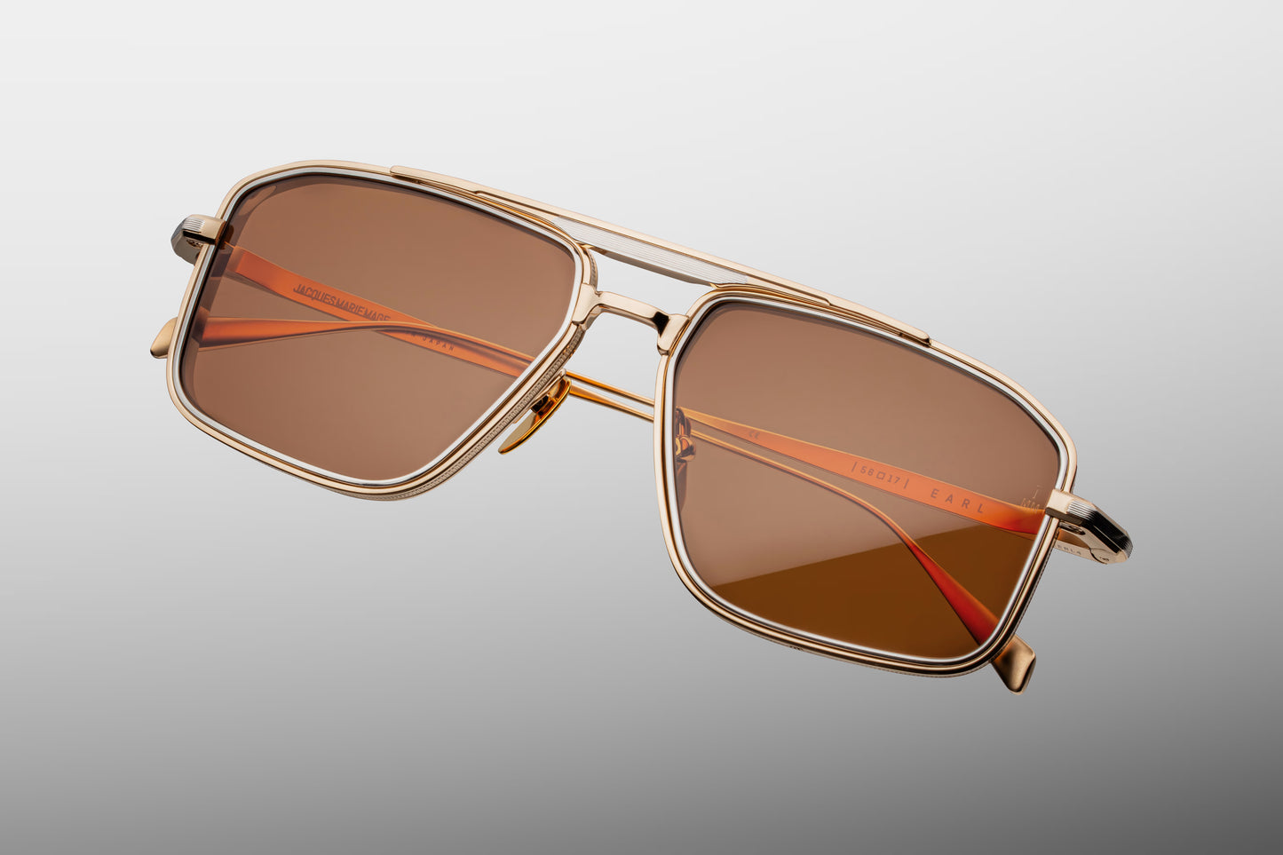  Top-down view of the JMM Earl Darjeeling sunglasses, revealing the geometric navigator curvature, the layered thickness of the 4mm metal eye-rims, and the streamlined custom titanium nose pads