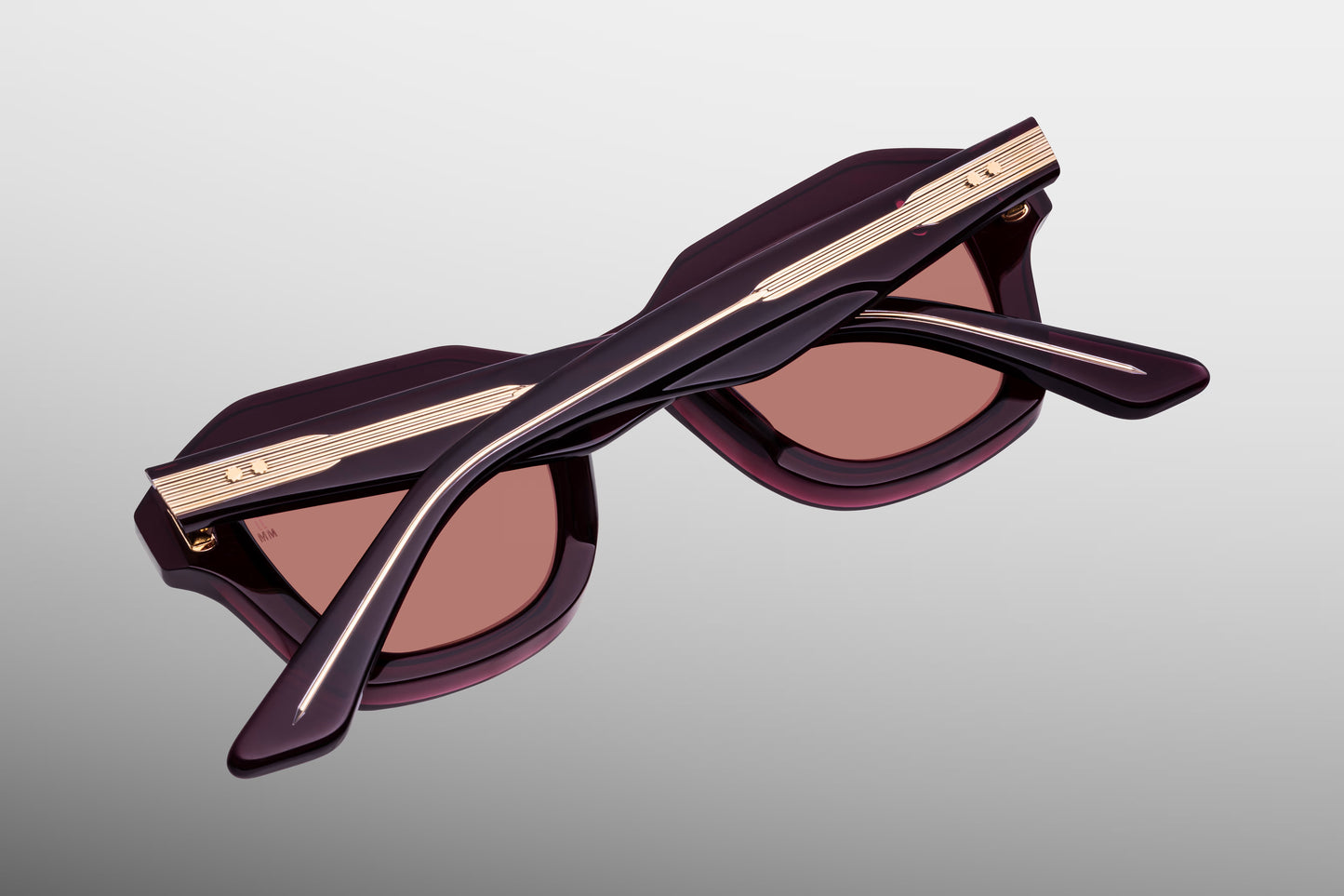Close-up back view of Jacques Marie Mage Eichler Amarena sunglasses showing inner temple engraving and exposed wirecore structure
Rear detail of JMM Eichler Amarena frame revealing handcrafted acetate interior and limited edition markings