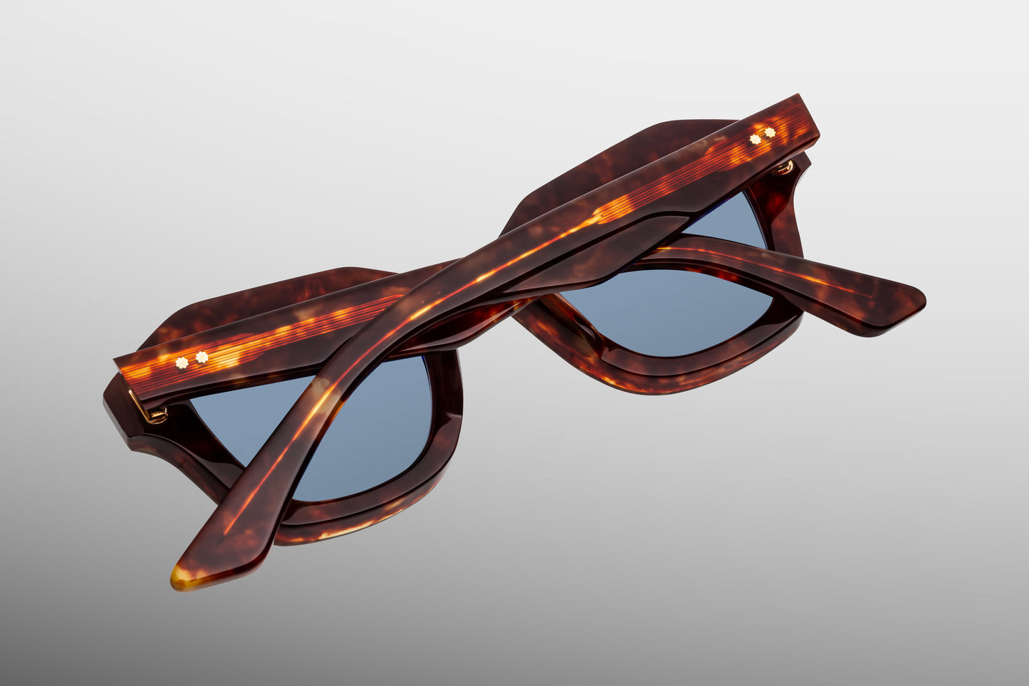 Close-up side detail of Jacques Marie Mage Eichler Breccia showing engraved wire core, ball hinge construction and slim sculpted temples
Macro side view of JMM Eichler Breccia highlighting premium hardware and precision acetate layering