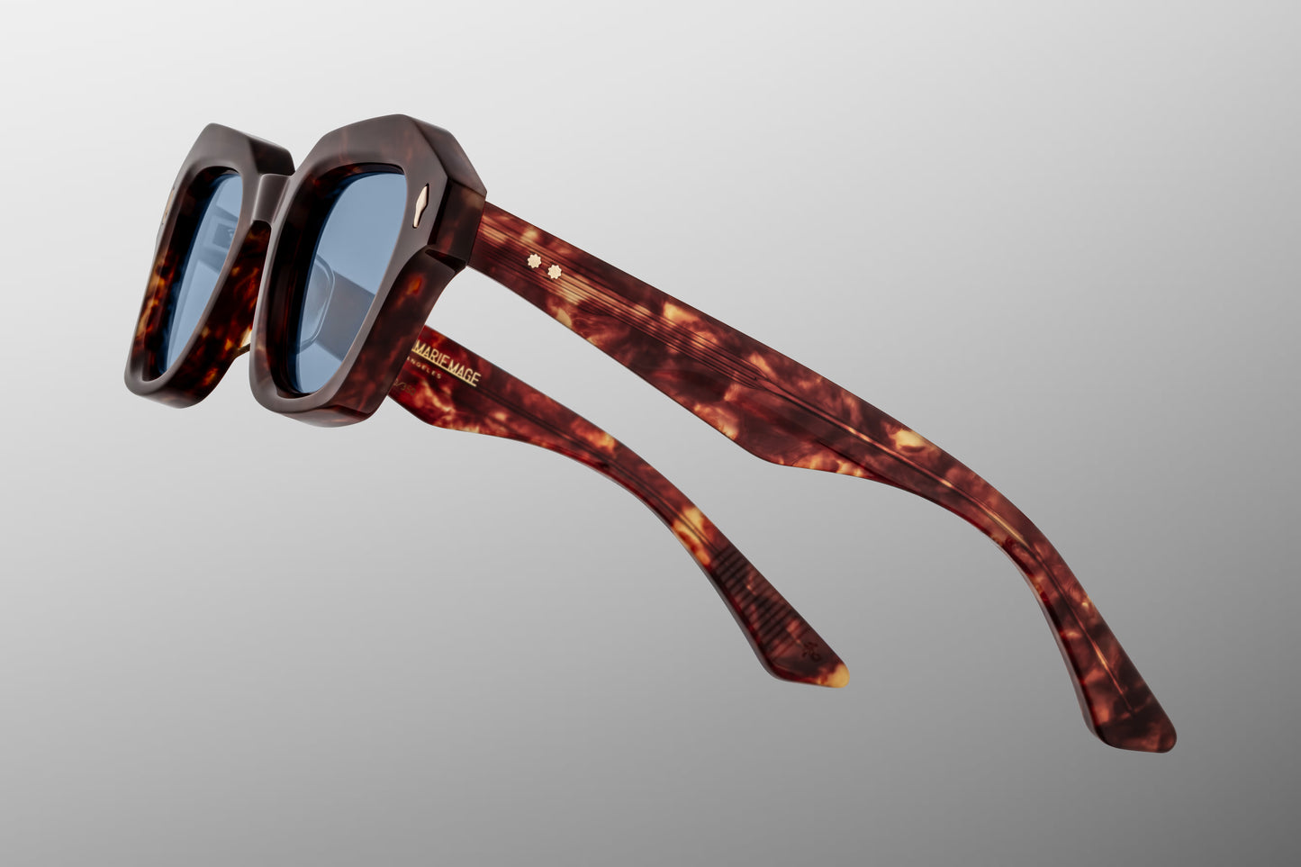 Close-up side detail of Jacques Marie Mage Eichler Breccia showing engraved wire core, ball hinge construction and slim sculpted temples
Macro side view of JMM Eichler Breccia highlighting premium hardware and precision acetate layering