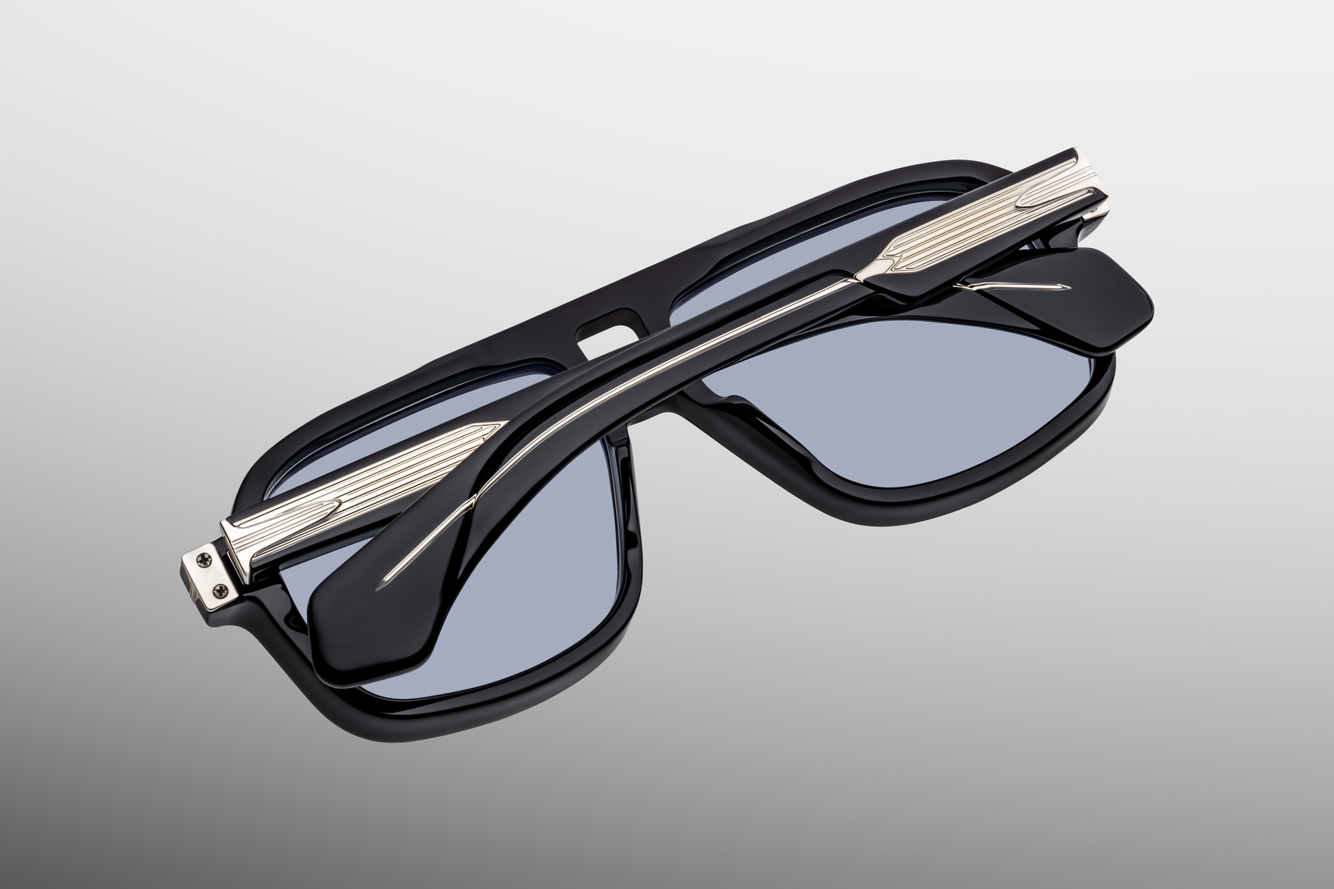 Folded Jacques Marie Mage Elkhart Obscure sunglasses showcasing bold navigator silhouette and handcrafted Japanese acetate – available at WINK Optometrists.