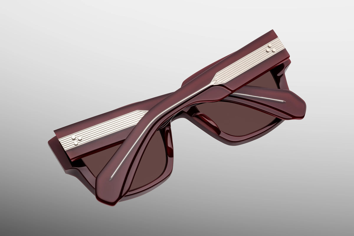  Inner rear view of Jacques Marie Mage Enzo Bordeaux Empire sunglasses, detailing the heavy-duty 7-barrel hinge with silver spur-shaped rivets and the limited-production batch number foil-stamped on the interior temple arm.