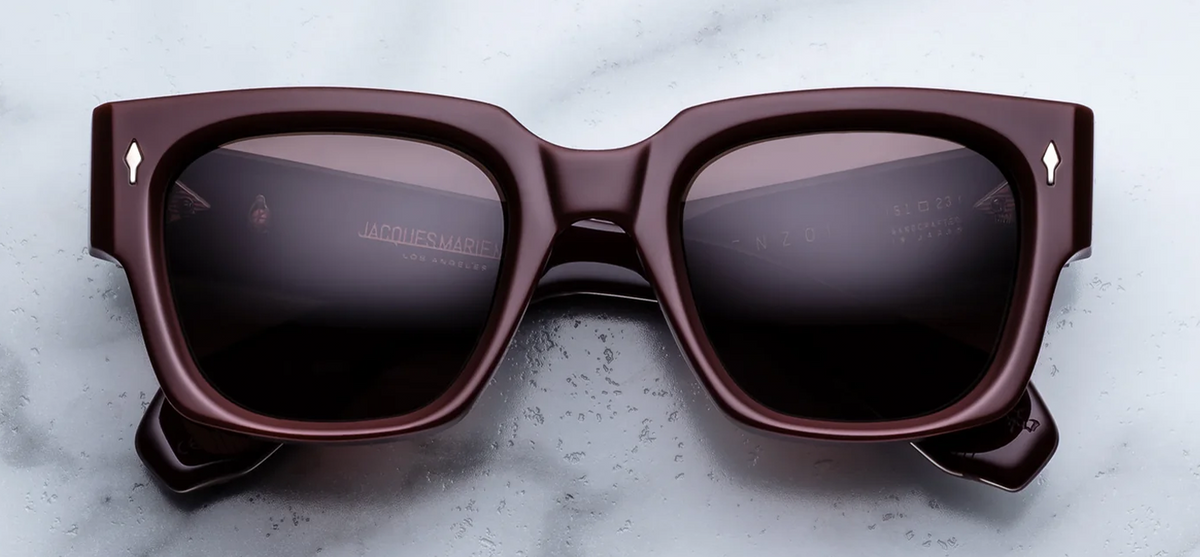 Front view of Jacques Marie Mage Enzo Bordeaux Empire sunglasses. Displays a bold, oversized square 10mm block acetate frame in a high-gloss deep wine-red burgundy, fitted with solid brown lenses and sterling silver arrowhead front pins.