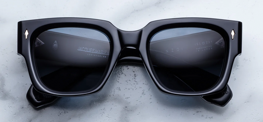 Front view of Jacques Marie Mage Enzo Lacquer sunglasses. Displays an oversized, powerful square 10mm block acetate frame in a high-gloss ink blue that borders on black, paired with solid dark blue lenses and light-gold arrowhead front pins.