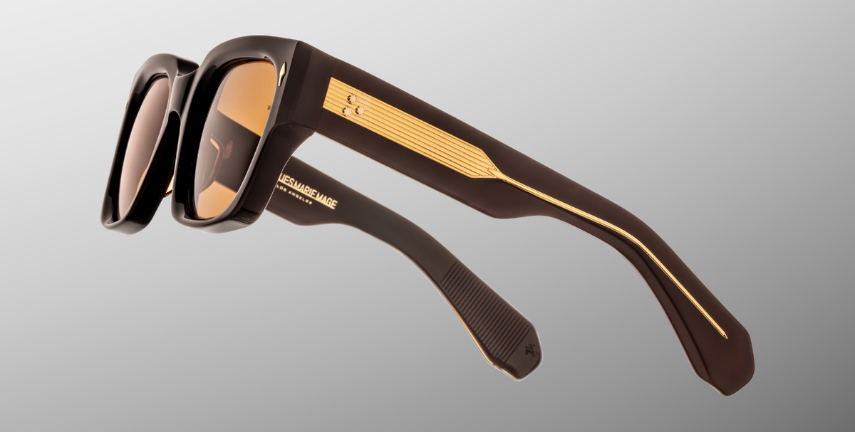 Temple detail of Jacques Marie Mage Enzo (Walnut) — focus on the walnut-brown temple, dark gold metal hardware, layered acetate finish and engraved wire-core design.