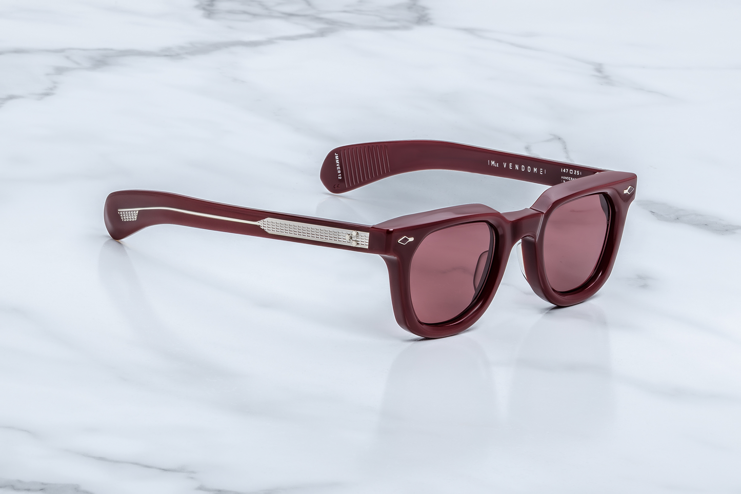 Side profile of Vendome Cassis — double-laminated temples in clear-over-cassis acetate, showing exposed ‘baguette’ patterned silver wire-core