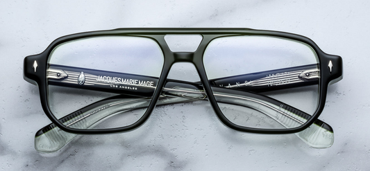 Front view of Jacques Marie Mage Evans Borneo eyeglasses showcasing deep forest‑green 8 mm cured cellulose acetate, ’60s‑inspired oversized navigator silhouette with bold double‑nose bridge and gold arrowhead front pins