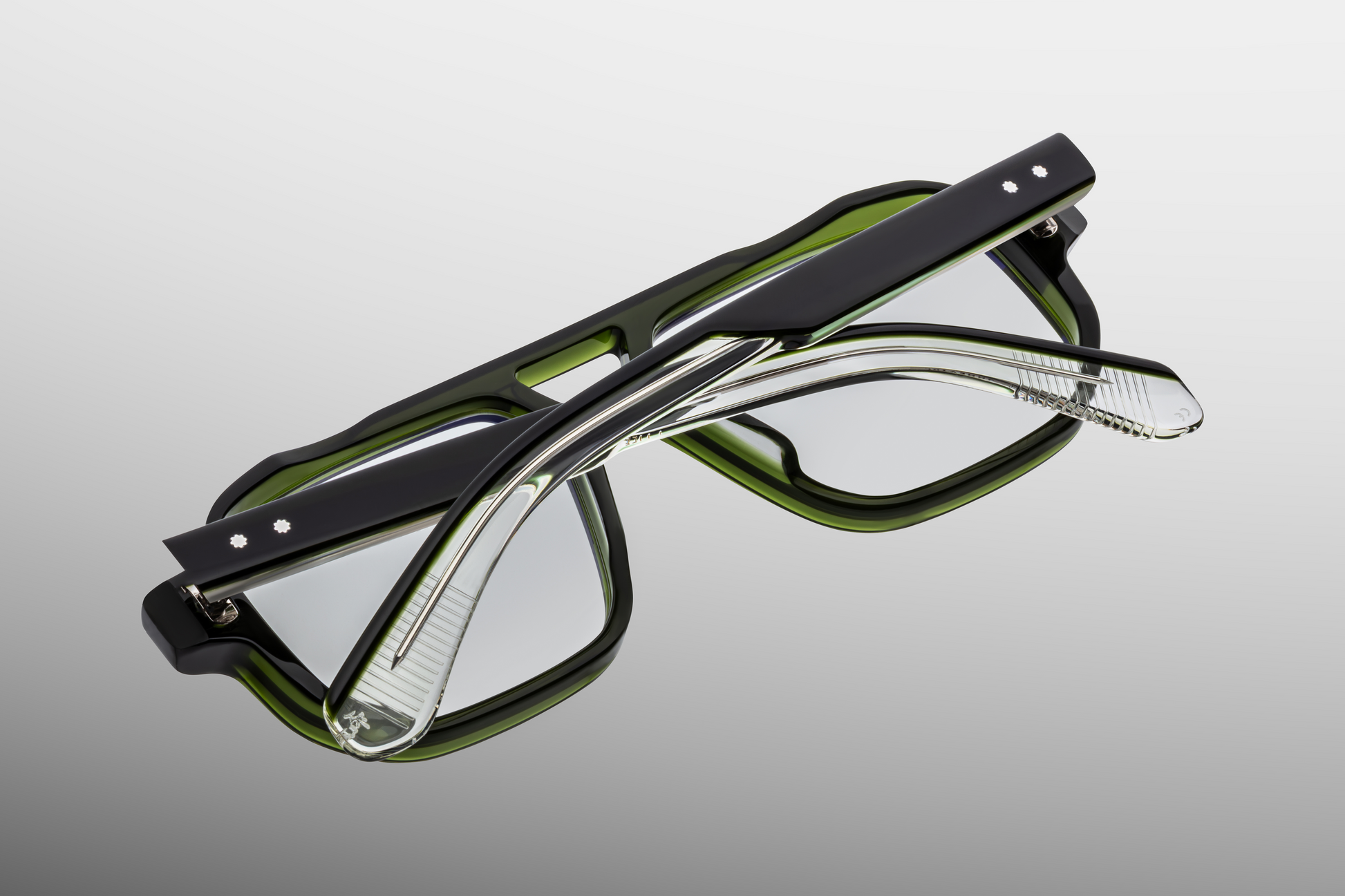 Rear view of Jacques Marie Mage Evans Borneo eyeglasses showing seamless forest‑green acetate backside, exposed silver wirecore visible through temple, double‑nose‑bridge structure, and limited production batch numbering