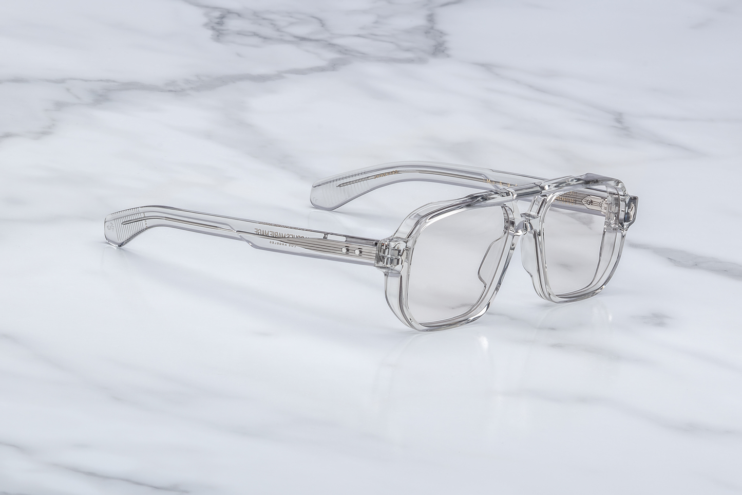 Side profile of Evans Sulfur highlighting custom double‑laminated sulfur acetate temples, exposed sterling silver filigree-engraved wirecore, sterling silver tension‑secured 7‑barrel hinge with spur-shaped rivets, and domed 3D metal cameo logo