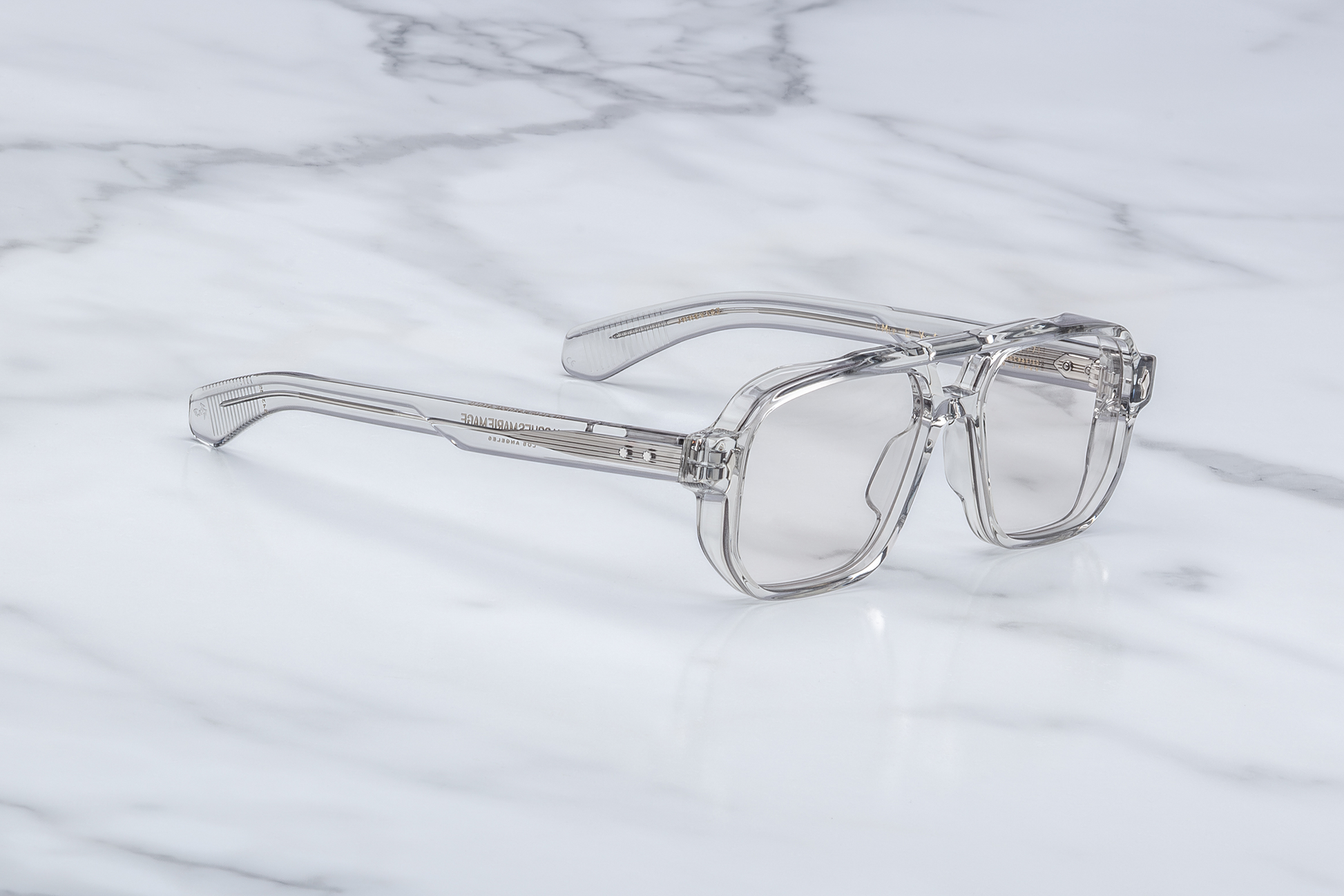 Side profile of Evans Sulfur highlighting custom double‑laminated sulfur acetate temples, exposed sterling silver filigree-engraved wirecore, sterling silver tension‑secured 7‑barrel hinge with spur-shaped rivets, and domed 3D metal cameo logo