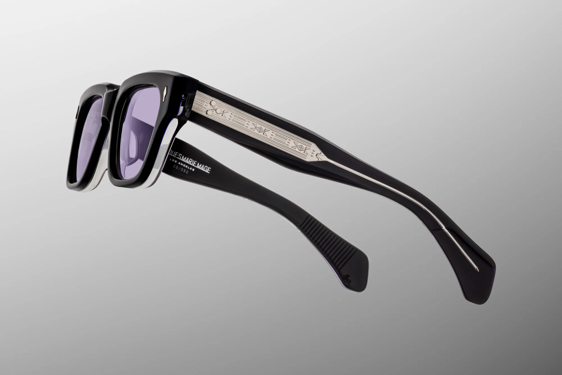 Close-up of Jacques Marie Mage Fellini Hudson temple detail featuring exposed engraved silver wirecore, signature arrowhead hardware and handcrafted Japanese acetate