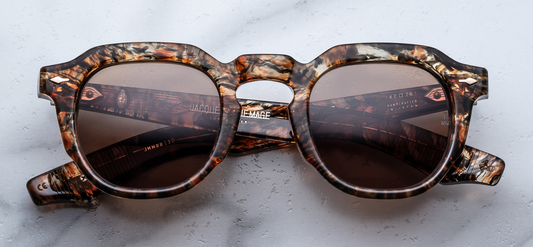 Front view of Jacques Marie Mage Firehole River glasses in Prismatic acetate, featuring Carab brown lenses and silver arrowhead front pins