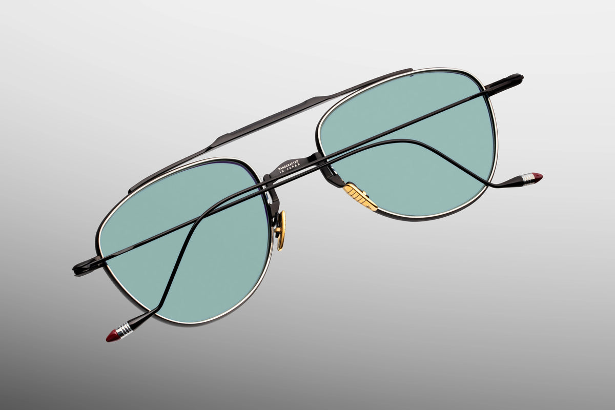 Inner rear view of Jacques Marie Mage Flynn Paon sunglasses, detailing the precision-engineered block hinge and the limited-production batch number foil-stamped neatly on the interior surface of the sleek titanium arm.