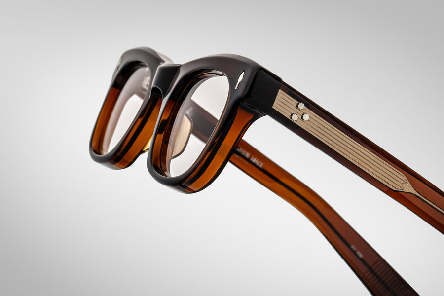 Right side of the Godard Zoltar — brown acetate arm showing delicate layering, signature silver arrowhead detail near the front, and hairline-engraved hinge