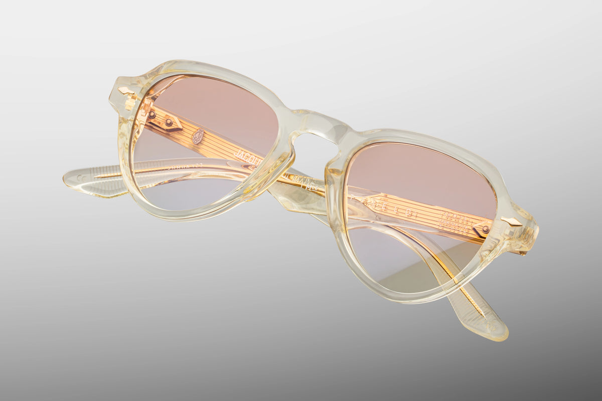 Top-down view of the Jacques Marie Mage Hatfield Halo photochromic sunglasses, emphasizing the substantial 10mm gauge thickness of the front block profile. From above, the clear champagne-beige alignment of the temples is fully visible, showcasing the internal light gold wire cores and the robust multi-barrel hinges. Available at WINK Optometrists.
