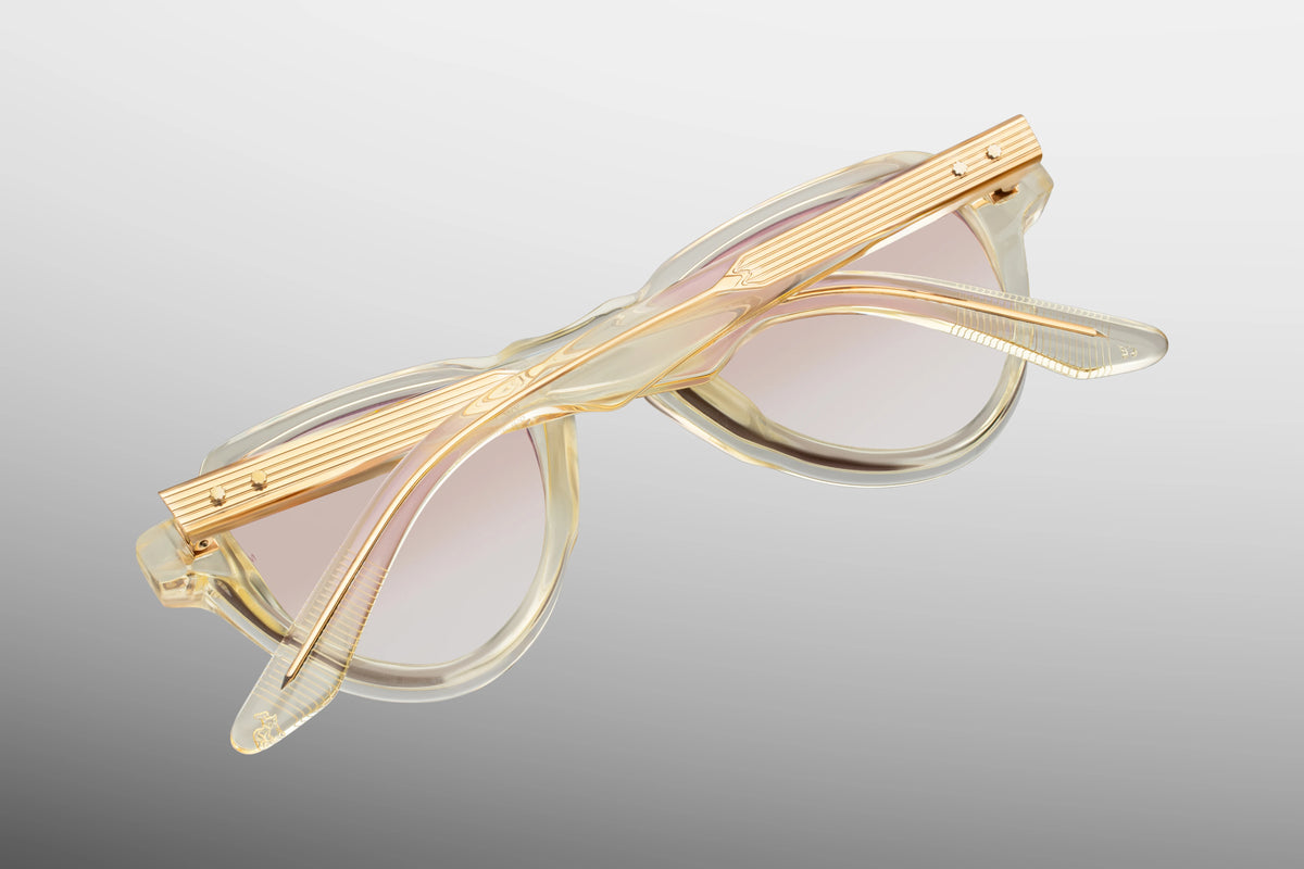 Close-up interior detail shot of the Jacques Marie Mage Hatfield Halo frame architecture. The inner view showcases the translucent beige rims against the premium light gold metallic hardware. Clean silver foil-stamped text on the inner temple arm indicates the individual limited-edition serial number out of the exclusive global batch of 300 alongside the "Handcrafted in Japan" production text. Available at WINK Optometrists.
