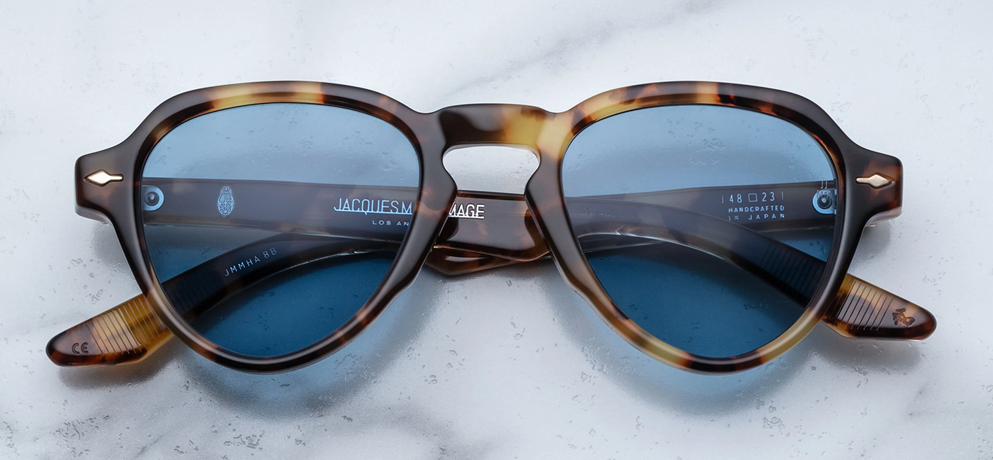 Front view of Jacques Marie Mage Hisao in Havana: full‑rim oval glasses with a rich tortoiseshell/havana acetate frame front, rounded lenses, single bridge. The rims are medium‑thick, with the warm brown and amber flecks typical of Havana finish. Clear lenses with silver hardware visible at the hinge