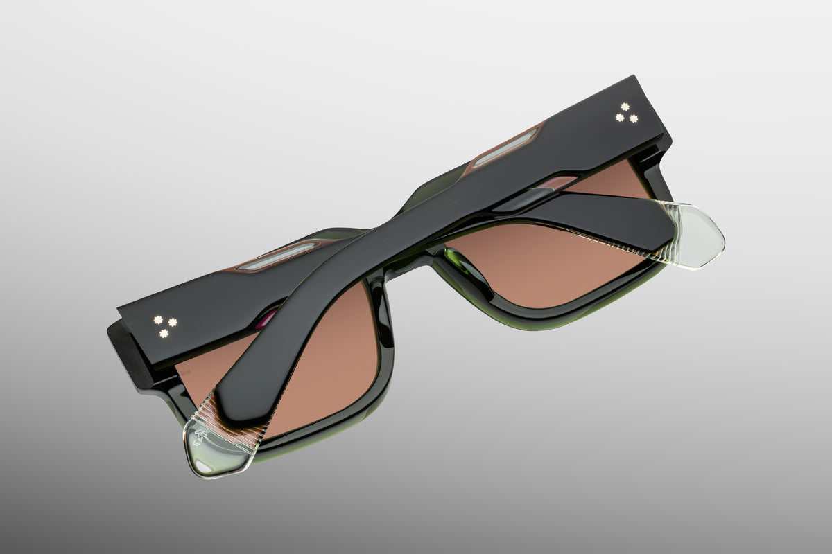  Interior back view of Jacques Marie Mage Hemmings Borneo sunglasses, showing the heavy-duty gold tension-secured 7-barrel hinge and the limited-production batch number stamped in gold foil on the inner temple arm. WINK OPTOMETRISTS