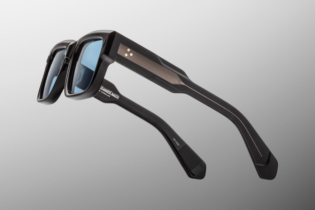 Close-up detail of the side temple of Jacques Marie Mage Hemmings Mystique sunglasses. The translucent acetate reveals the intricate, custom hairline-engraved precious metal wire core running through the arm, showcasing fine filigree craftsmanship.