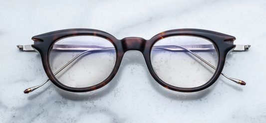 Front view of Jacques Marie Mage Hisao optical glasses in Havana, featuring rectangular amber-brown acetate frames with clear lenses and sculpted detailing
