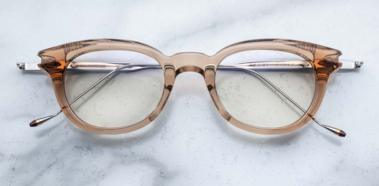 Front view of Jacques Marie Mage Hisao optical glasses in Sand, featuring a rectangular silhouette crafted from translucent beige acetate with clear lenses