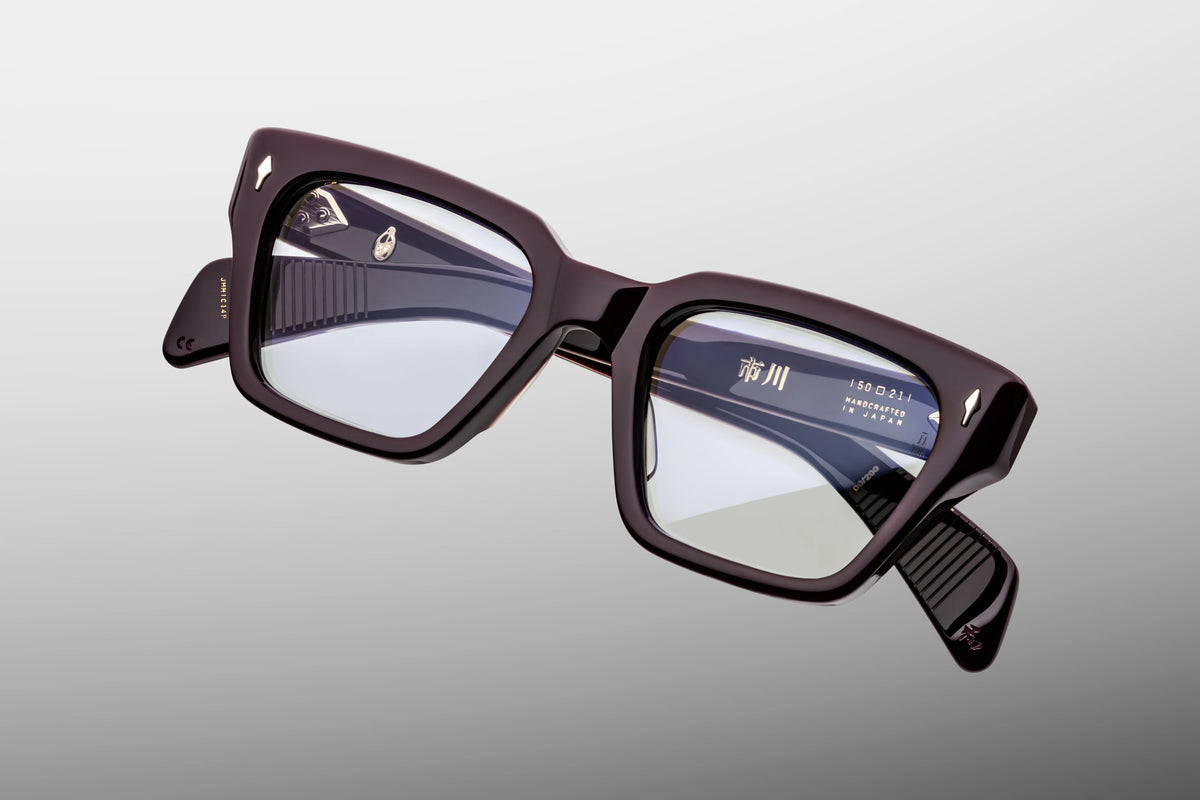  Top-down view of the Jacques Marie Mage Ichikawa Wine RX eyeglasses, emphasizing the dramatic 10mm gauge thickness of the front block acetate profile. From above, the dual-laminated construction of the temples is fully visible, highlighting the pristine parallel alignment of the exposed internal silver wire cor