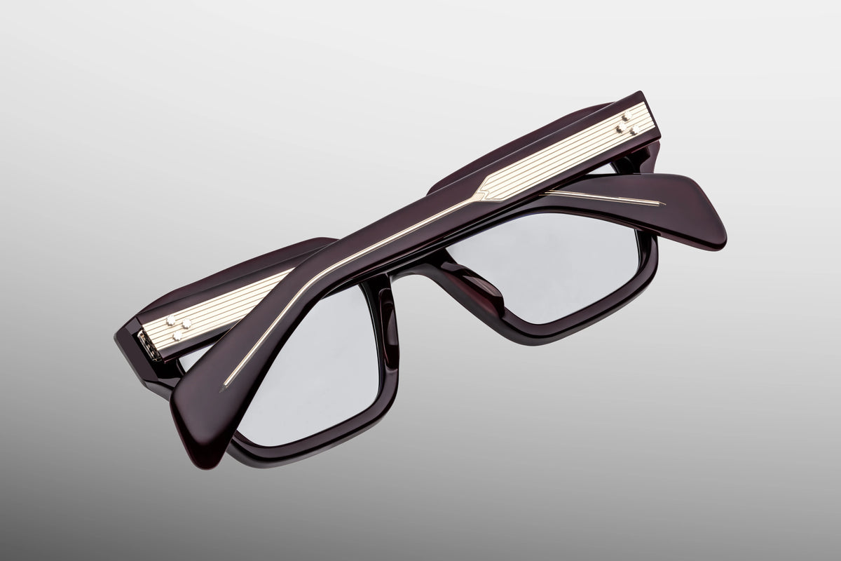 Close-up interior detail shot of the Jacques Marie Mage Ichikawa Wine RX frame architecture. The inner view showcases the deep burgundy-red rims against the exposed metallic hardware. Gold foil-stamped text on the inner temple arm indicates the individual limited-edition serial number out of the exclusive global batch alongside the "Handcrafted in Japan" production text. Available at WINK Optometrists