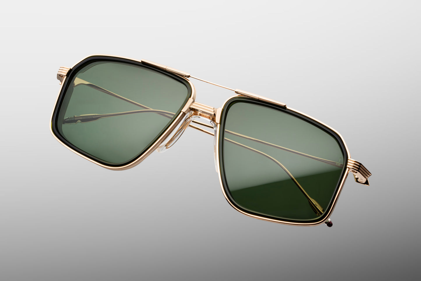 Top-down view of the JMM Jagger Cypress frame, revealing the wide square aviator geometry, structured light gold titanium brow bar, clear nose pads, and robust titanium hinge construction