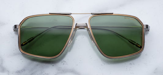 Front view of Jacques Marie Mage Jagger glasses from the Decades Collection in Electrum, featuring bold geometric gold-toned frames with light lenses and subtle side shields integrated into the temples